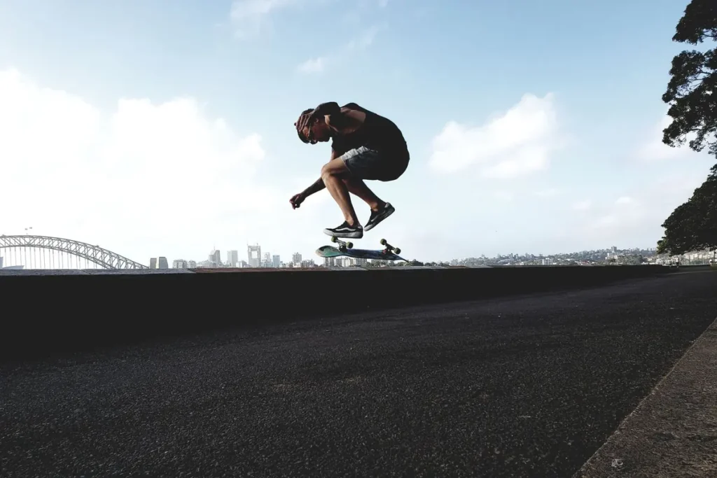 A skateboarder doing a trick near the Sydney Harbour Bridge