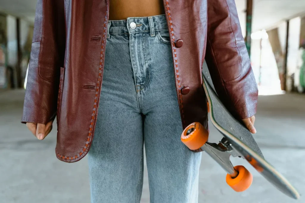 Close-up of a person holding a skateboard at a skatepark