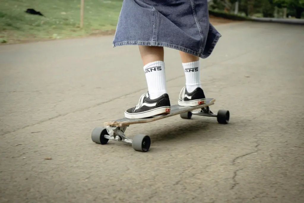 A person riding a skateboard on pavement