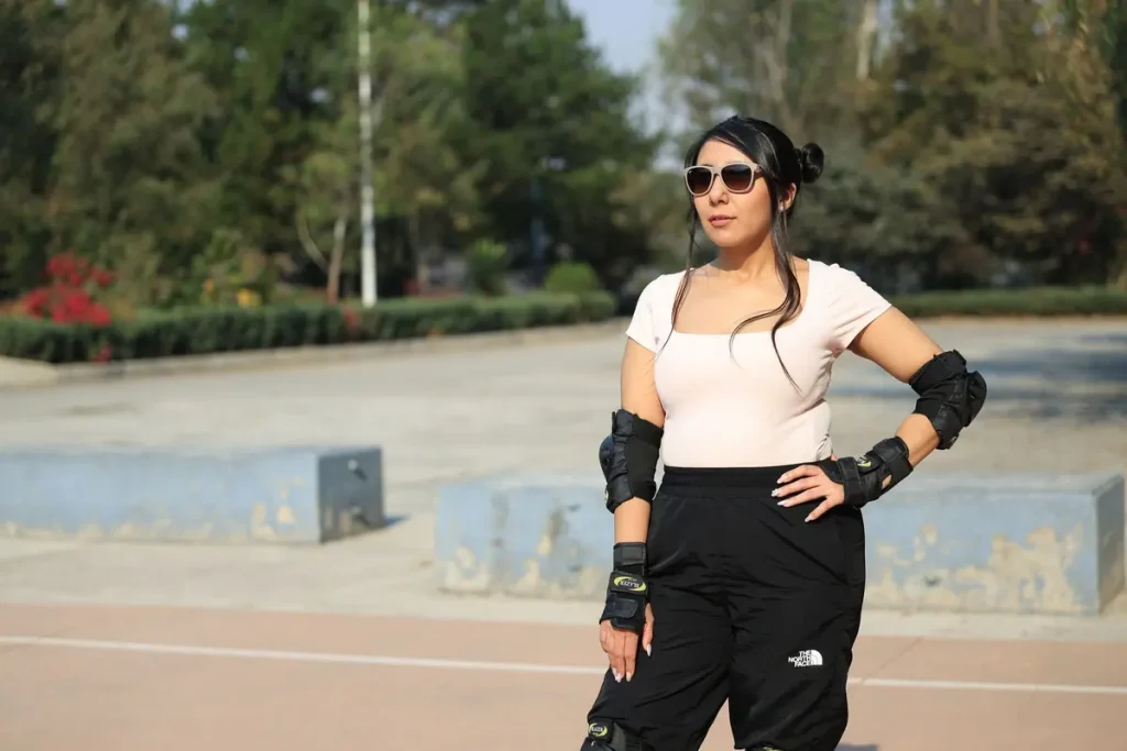 A woman wearing protective pads and sunglasses