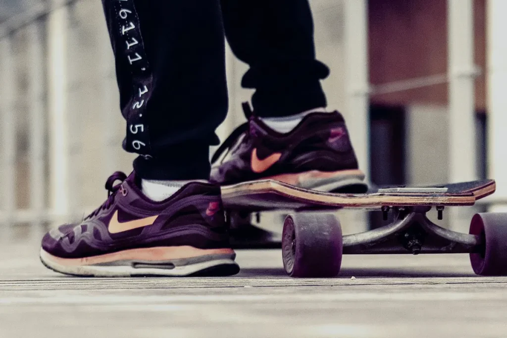 Close-up of a skateboarder's sneakers on a wooden deck