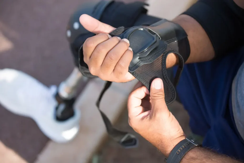 A skateboarder fastening a wrist guard