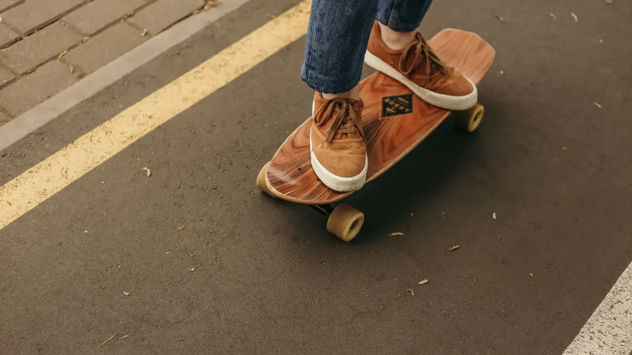Close-up of a person skateboarding on a city street