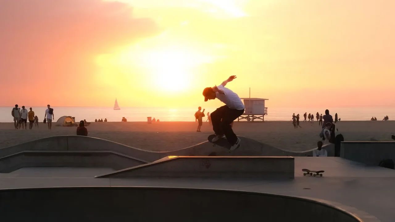 A skateboarder at the Venice Beach skatepark at sunset